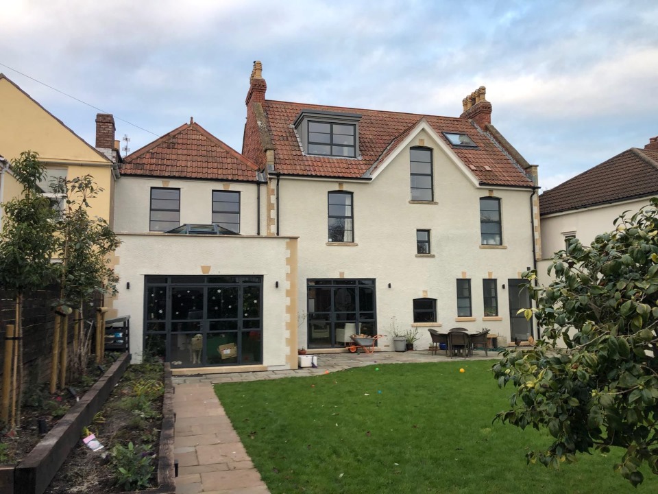 Large white three-storey Bristol house with red tiled roof after a loft conversion